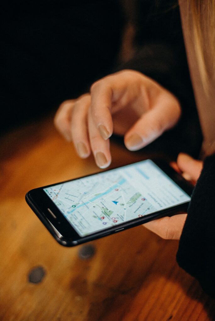 Hand holding a smartphone showing a map Hand holding a smartphone showing a map